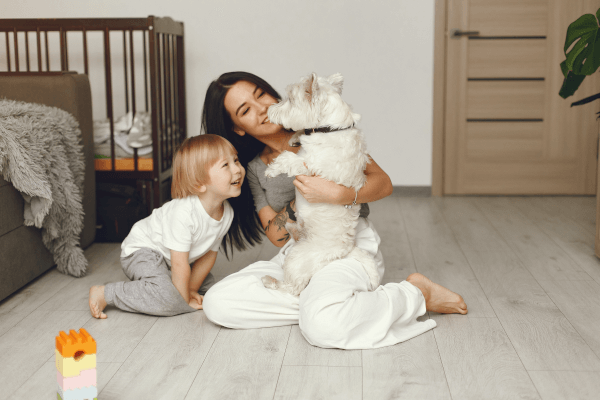 Joyful family moment with their pet dog