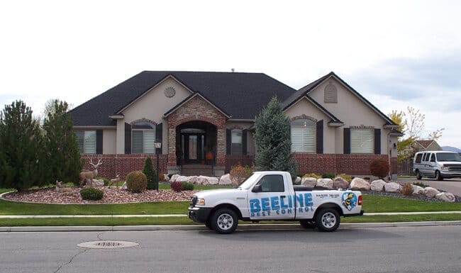 Beeline Pest Control truck in front of a residential home.