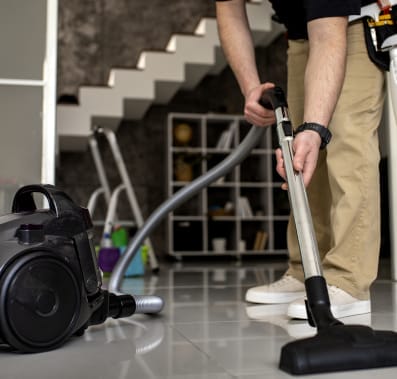 man-doing-professional-home-cleaning-service - Beeline Pest Control Man doing a vacuum cleaning